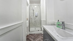 Ein modernes Badezimmer mit Dusche, Waschbecken und Toilette.