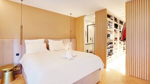 A modern hotel room with a large bed, a bedside table, a wardrobe, and a bathroom visible through a sliding door. - Chic Apt With Garden - 1bd/2p - Neuilly-sur-seine (Neuilly-sur-Seine)
