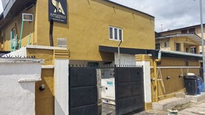 A building with a sign for "Appleville Suites" and a gated entrance. - Appleville Suites (Lagos)