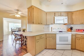 Enjoy cooking in this well-equipped kitchen with a microwave, oven, and spacious island with seating.