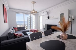 Deluxe Apartment, Balcony, City View | Living area | 43-inch LED TV with cable channels - 30th Floor-Skyline above a City (Skopje)