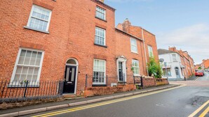 A red brick building with multiple windows and a black door. - Host Stay Park Street Abode (Worcester)