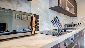 A modern kitchen with a marble countertop, a built-in oven, and a coffee machine. - Host Stay Shaw Street Suite (Worcester)