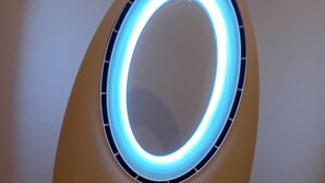 Un appareil JOCCA doté d’un élément lumineux circulaire, de boutons de commande et d’un câble d’alimentation.