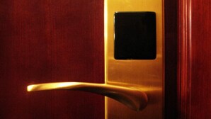 A door with a metallic handle and a digital lock. - LIS CHAIN HOSTEL (Kowloon)