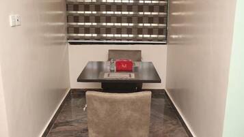 Deluxe Apartment, Balcony, City View | Dining room