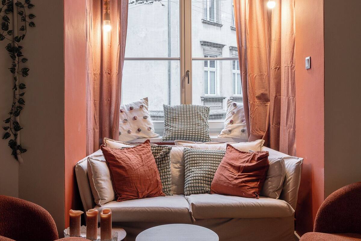 A cozy seating area with a sofa, two armchairs, and a round coffee table.