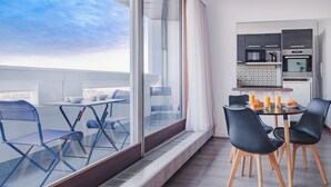 A modern kitchen with a microwave, oven, and tiled backsplash. - Paris Expo 2 Residence (Paris)