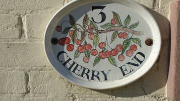 A house number plaque with the number 3 and the words "Cherry End" on a white background.