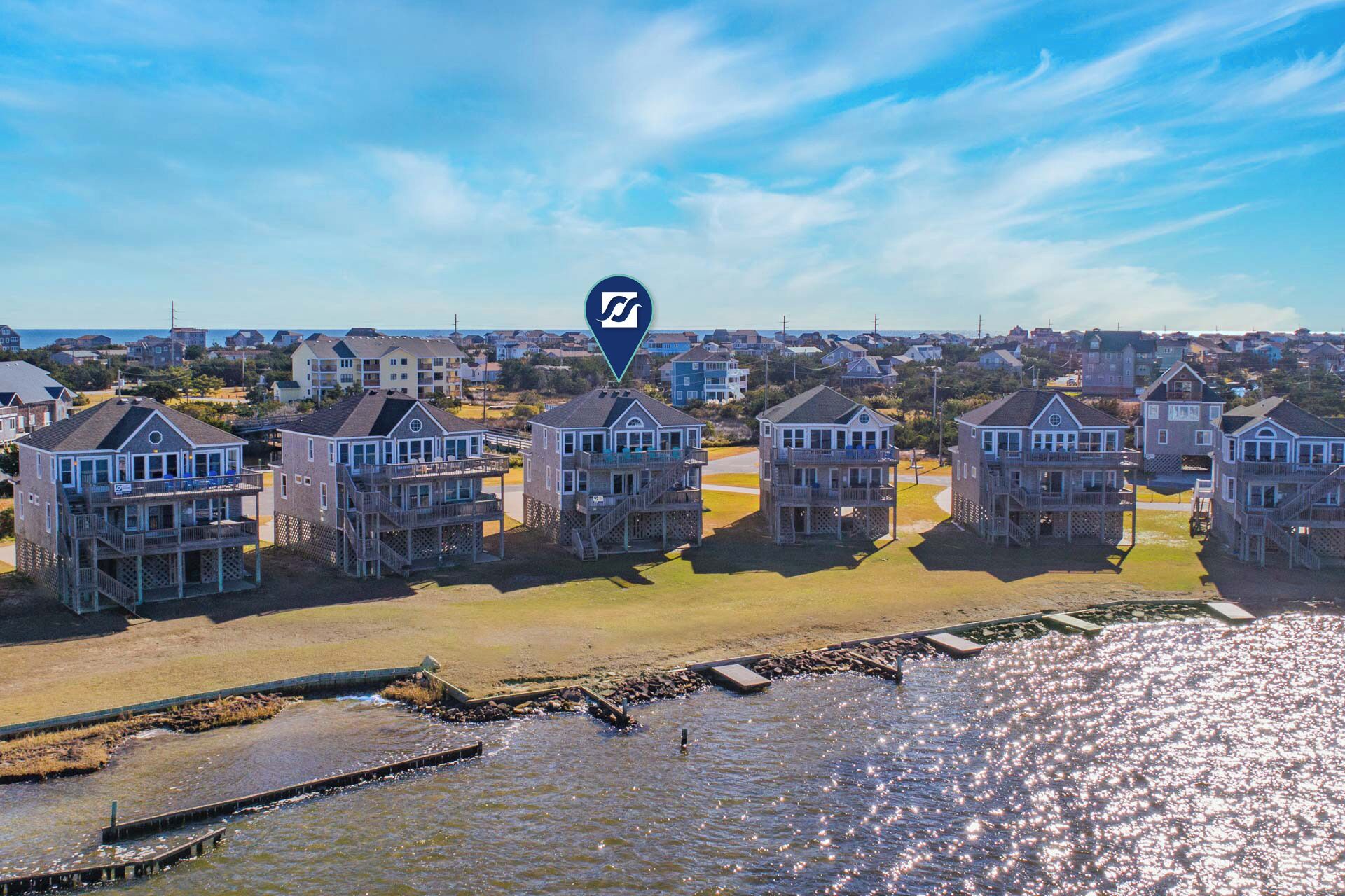 A coastal residential area with beachfront houses featuring balconies and decks.