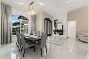 Enjoy meals with friends and family in this spacious dining area with a large window offering a view of the surrounding neighborhood.