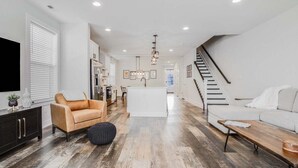 A modern living room with a sofa, ottoman, and a coffee table. - Bethany Beach * New Modern Luxurious Townhome - 4 (Ocean View)