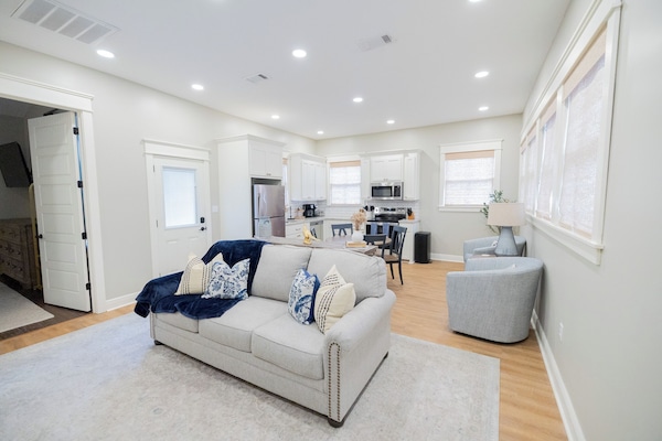 - Open concept layout brings the kitchen, dining, & living areas together with ease - Comfy sofa with plush pillows invites you to relax just steps from the kitchen - Natural light & soft tones create a bright, welcoming space to gather & unwind