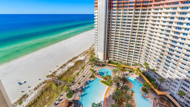 A high-rise hotel with a pool area, beach access, and ocean views. - Modern condo w/ resort amenities & Gulf views (Panama City Beach)