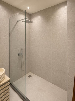 A modern shower with a glass door, a handheld showerhead, and a wall-mounted control panel. - New White Pyramids Inn (Giza)