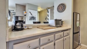 A kitchen with a coffee maker, toaster, and refrigerator. - Mountain Nest Retreat Ground Level Condo Brian Head (Brian Head)