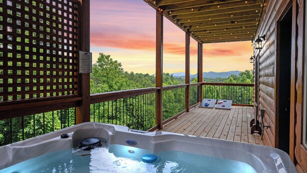 A wooden deck with a hot tub, wooden railings, and a view of the mountains. - VIEWS FROM THE MOUNTAIN TOP is Ready for Company (SEVIERVILLE)