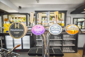 A bar with four beer taps labeled with different brands. - Unique Exclusive Pub Sleeping up to 26 People (Pontardawe)
