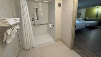 A modern bathroom with a shower, a towel rack, and a visible shower curtain.