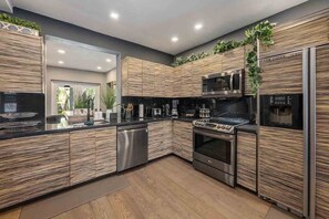 Enjoy cooking in this well-equipped kitchen with a large island and planters.