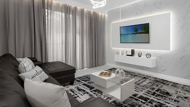 A modern living room with a sofa, ottoman, and coffee table. A TV is mounted on the wall, and there are decorative items below it. - 4BR house at Storey Lake Resort 9min Disney (Kissimmee)