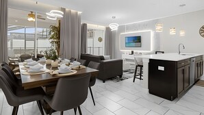 A modern kitchen with a central island, a dining area with a large table and chairs, and a living space with a sofa and a TV mounted on the wall. - 4BR house at Storey Lake Resort 9min Disney (Kissimmee)