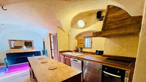 A kitchen with wooden countertops, a built-in oven, and a dishwasher.