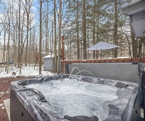 A hot tub outdoors with a wooden deck, surrounded by trees and a shed. - Gated Arrowhead Retreat Private Hot Tub Fire Pit (Coolbaugh Township)