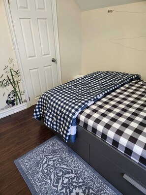 Cozy retreat with a neatly made bed and a minimalist design.