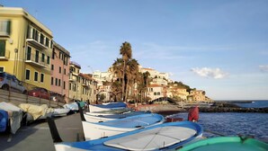 A coastal town with colorful buildings, boats docked along the shore, and a clear sky. - Apartment 'Giardino Miramare' with Sea View, Wi-Fi and Air Conditioning (Imperia)