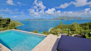 Cielo azzurro limpido, una piscina e vista sul mare e sulle montagne.