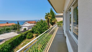Ein Balkon mit Blick auf das Meer und eine Küstenstadt.