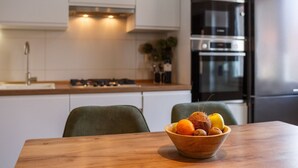 A modern kitchen with white cabinets, a wooden countertop, and a stainless steel refrigerator. - Fascinating holiday home just 500 metres from the beach with sea views, whirlpool, barbecue (Dramalj)