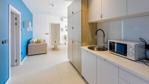 A modern kitchen with white cabinets, a stainless steel sink, and a microwave. - Exquisite flat with sea view, sauna, gym, pool, air-conditioned bedrooms - only 500 metres to the beach (Crikvenica)
