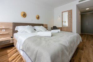 Relax in comfort with a large bed, wooden headboard, and a convenient desk area.