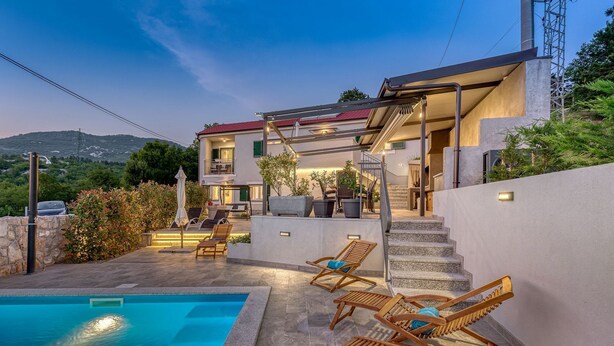 A modern villa with a swimming pool, outdoor seating, and a staircase leading to a balcony. - Villa Leticija (Hreljin)