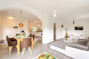 Enjoy a spacious living space with a dining area, kitchen, and cozy seating area.