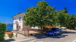 A coastal building with a car parked in front.