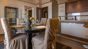 A modern dining area with a round table set for four, surrounded by cushioned chairs. - Unique flat with magnificent sea views, pool, BBQ and only 700 metres to the beach (Crikvenica)