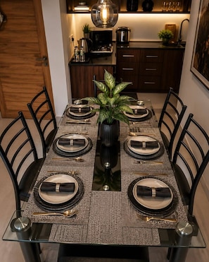 A dining table set with plates, cutlery, and a centerpiece.