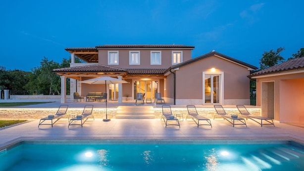 A two-story house with a swimming pool, outdoor seating, and a covered patio area. - Impressive villa with panoramic views, private pool, table tennis, table football, playground, baby cot (Pazin)