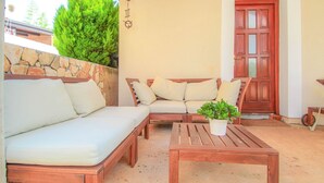 An outdoor seating area with a sofa, two armchairs, and a wooden table. - Charming studio flat with Mediterranean garden, barbecue, sun lounger, WiFi (Novigrad)