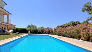 A rectangular swimming pool with a clear blue water surface, surrounded by a tiled deck. - Idyllic flat with sea view, pool, barbecue, washing machine, private car park (Novigrad)