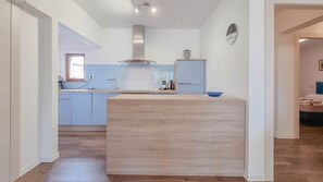 Fridge, stovetop, dishwasher, coffee/tea maker
