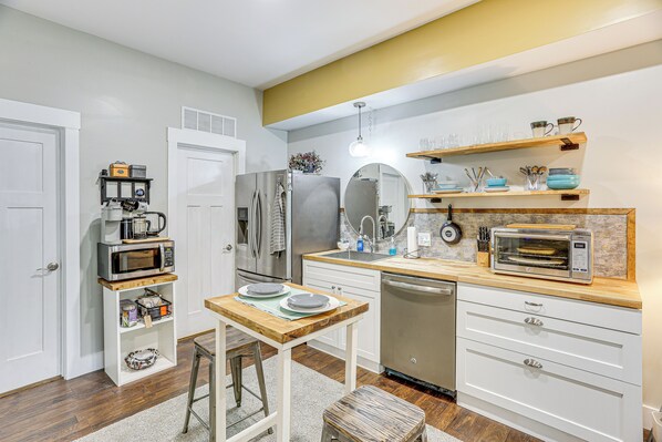 A compact kitchen with white cabinetry, a wooden countertop, and a built-in oven. - 6 Mi to Downtown: Apartment in Chattanooga! (Chattanooga)