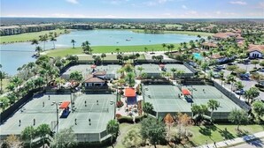 A resort with tennis courts, a pool, and a view of the surrounding landscape. - Bonita National Coach home, offers endless amenities for everyone  (Bonita Springs)