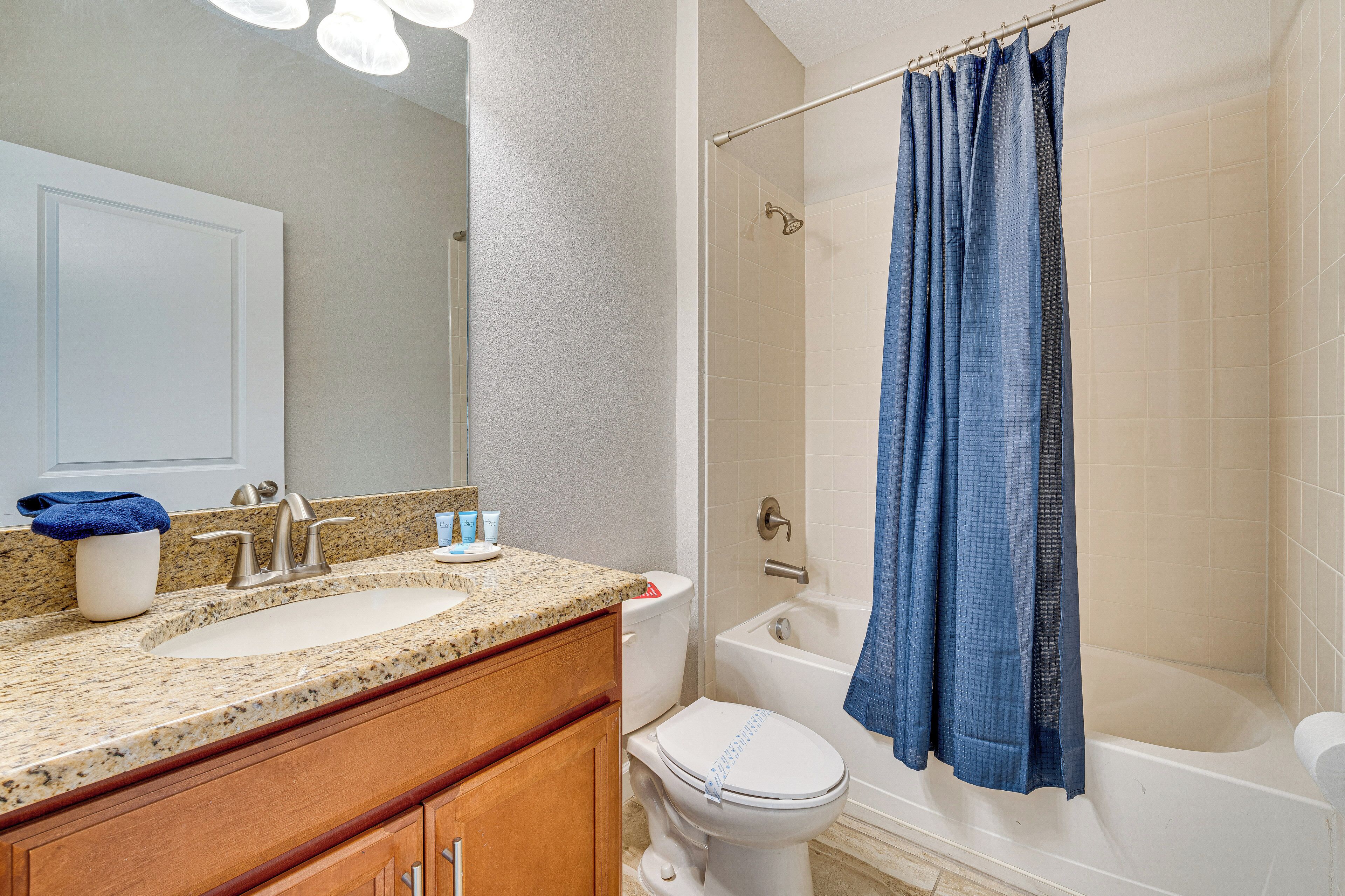 A bathroom with a sink, toilet, and bathtub.