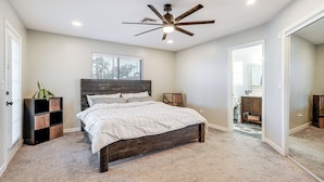 A bedroom with a bed, a ceiling fan, a window, and a door leading to another room. - 3 Mi to London Bridge: Home w/ Patio & Grill! (Lake Havasu City)