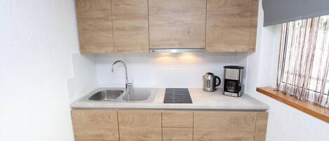 Fridge, stovetop, dishwasher, coffee/tea maker