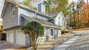 A two-story house with a garage, a covered porch, and a gravel driveway. - Cozy Country Livin! Gem 17 Mi to Lakepoint Sports (Woodstock)
